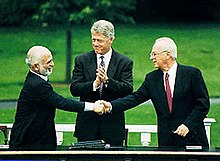 לחיצת יד בין חוסיין, מלך ירדן, ויצחק רבין, ברקע ביל קלינטון במעמד "הצהרת וושינגטון", ספטמבר 1994