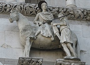 Saint Martin partageant son manteau, statue équestre ornant la façade de la cathédrale Saint-Martin de Lucques, début XIIIe siècle.