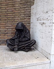 Eternal beggar, in front of the main entrance of Santo Spirito Hospital