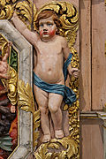 Putto du retable de saint Jean-Baptiste dans l'église Notre-Dame de Lampaul-Guimiliau.